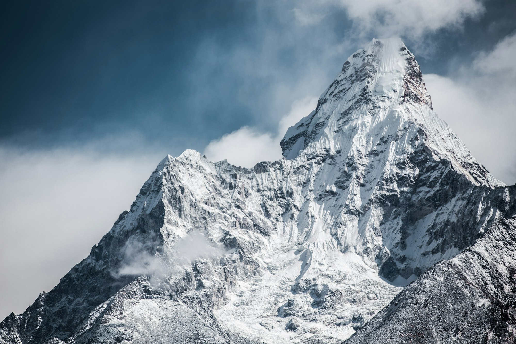 A snow-capped Himalayan peak rising into a moody dawn sky above the Kathmandu Valley