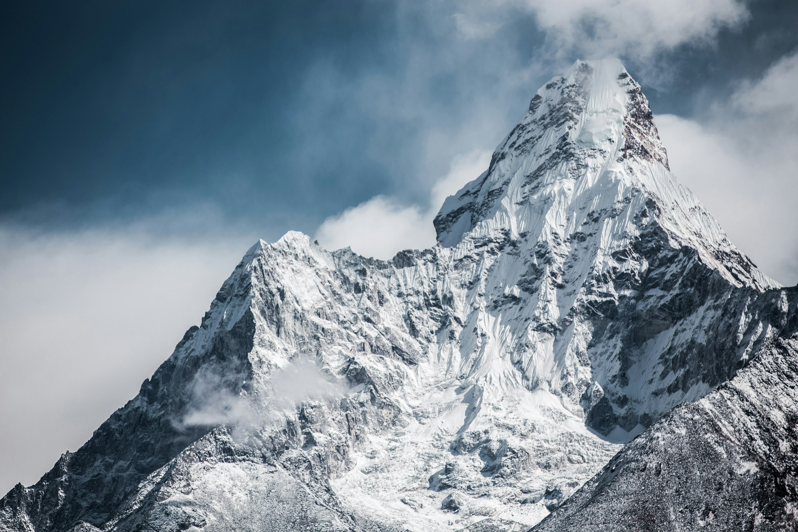 A snow-capped Himalayan peak rising into a moody dawn sky above the Kathmandu Valley