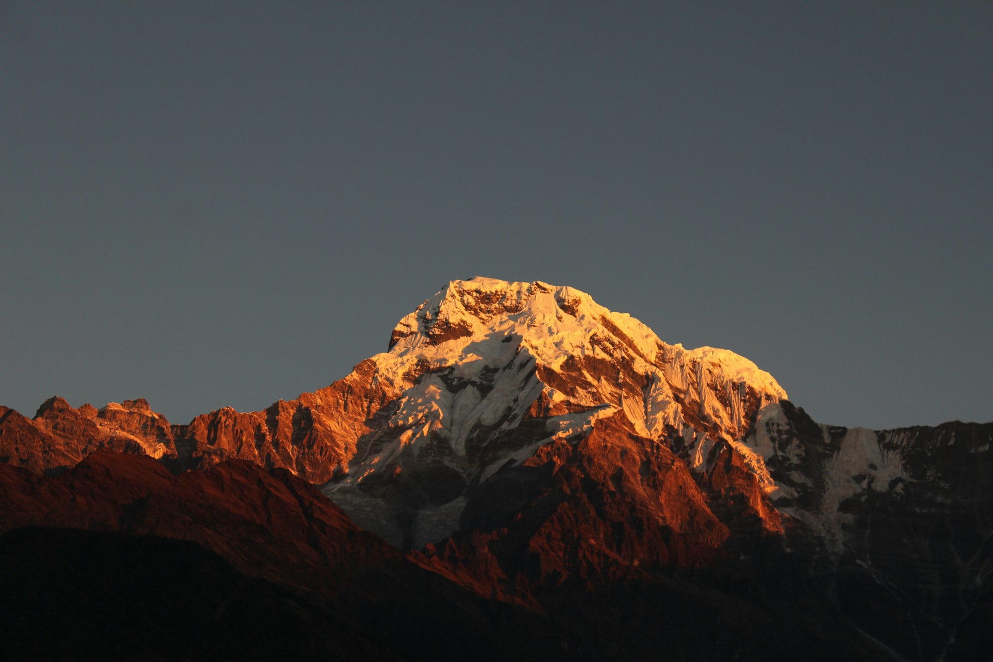 Stone Himalayan village beneath snow-dusted peaks in the Manaslu region, Nepal