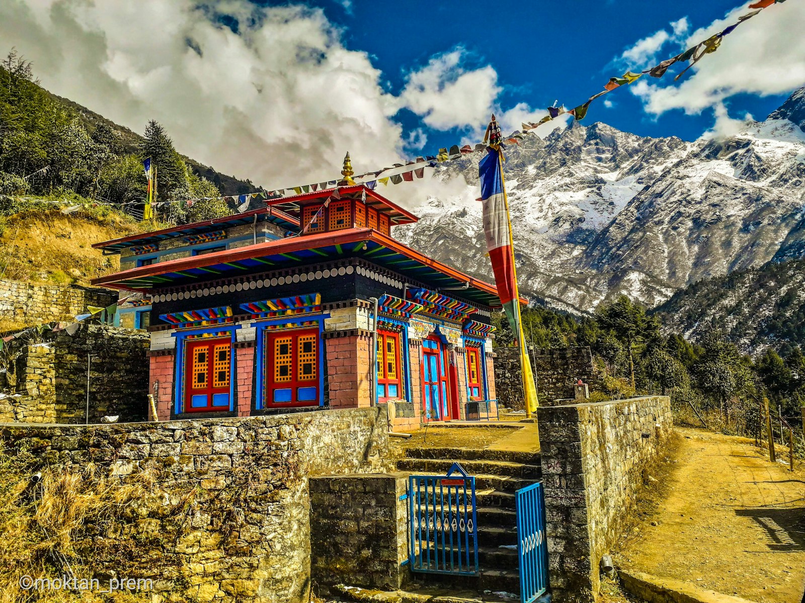 Stone mountain settlement set beneath cloud-wrapped Himalayan peaks, Nepal