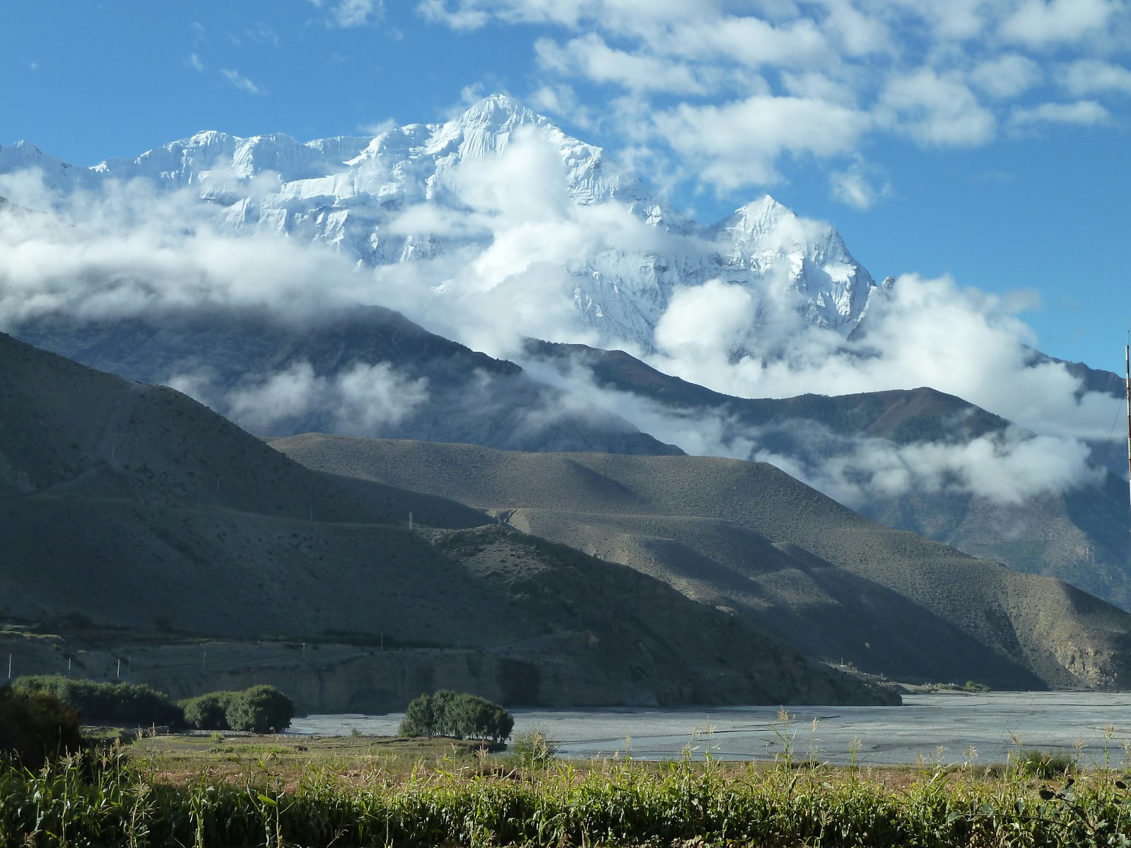 The Kali Gandaki valley floor in Mustang with a snow-capped peak rising above arid ridges, Nepal