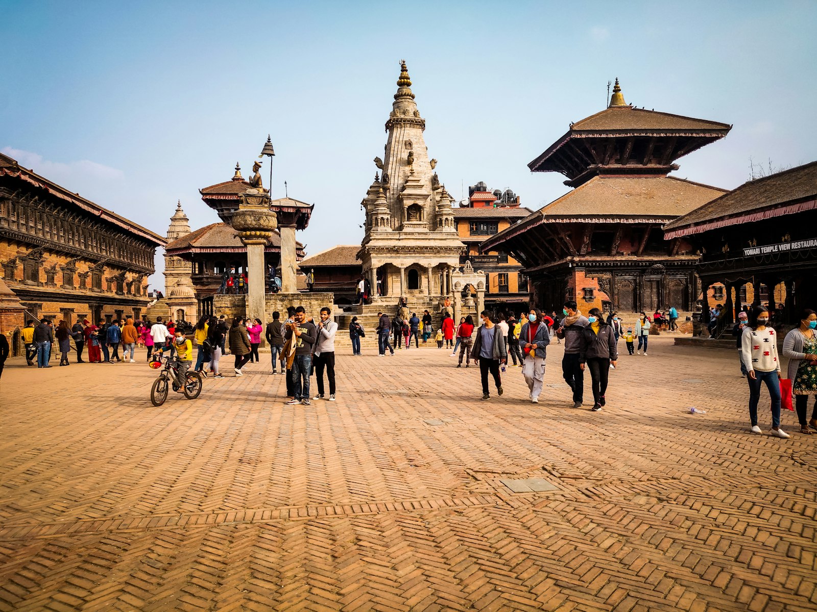 People walking the brick lanes and temples of Bhaktapur Durbar Square, Nepal