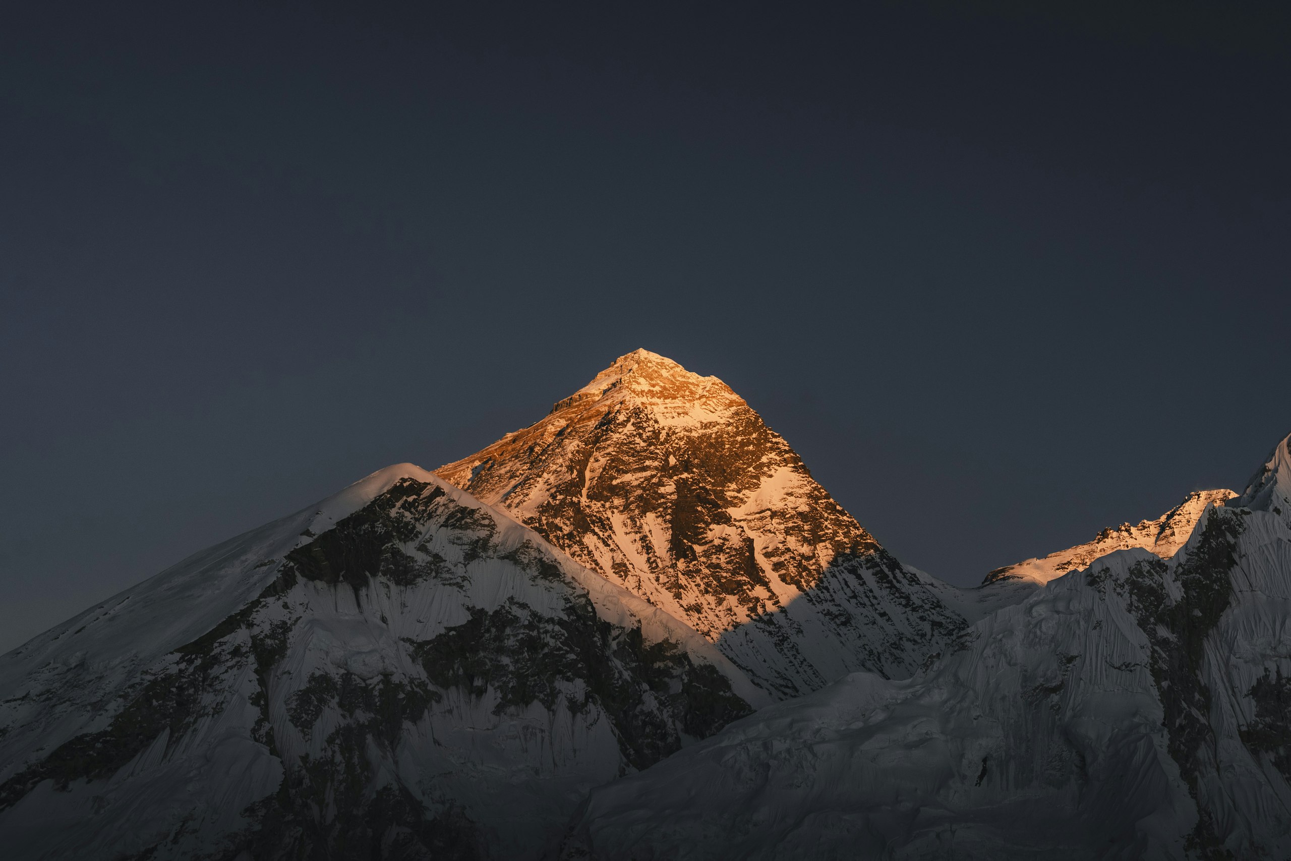 Mount Everest glowing in golden first light at sunrise, Khumbu, Nepal